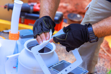 Hand in gloves cleans inspects filtration system parts to swimming pool working remote construction...