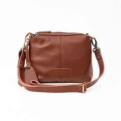 Blank brown leather sling bag for woman isolated on white background, perfect for leather product...