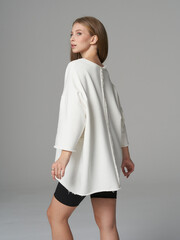 Elegant woman showcasing modern fashion in a stylish studio setting