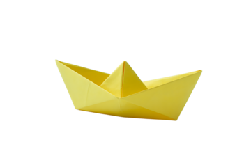 A vibrant yellow origami paper boat isolated on a black background with abstract green and blue accents