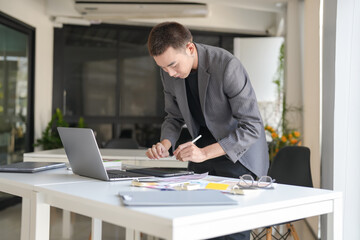 Business asian Man Artist Creative Designer sketch graphic drawing on graphic laptop and Color swatch samples Concept of idea creativity