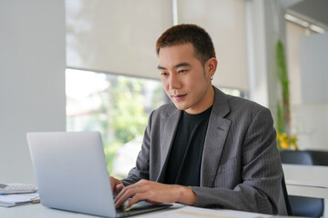Fototapeta premium Business man working using laptop computer Hands typing keyboard. Professional investor working start up project. business planning in office. Technology business