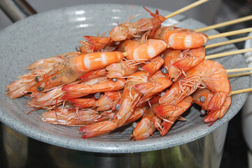 Raw prawn satay on a plate