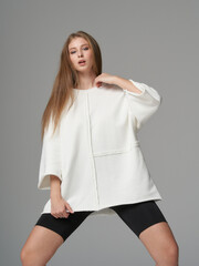 Elegant woman showcases modern fashion in a chic studio, radiating style and confidence