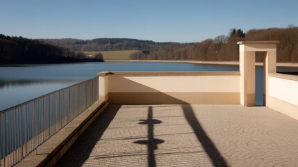 Naklejka premium serene reservoir edge in germany showcasing long shadows and natural symmetry