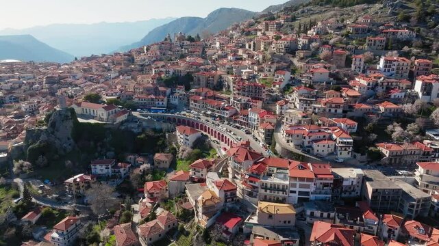 Arachova mountain town clock tower, uphill houses, cobbled streets, Greek National Highway 48, Boeotia, Drone shot, Establishing
