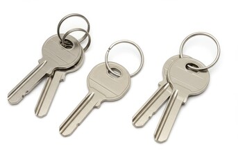 Three sets of keys with metal rings isolated on white background
