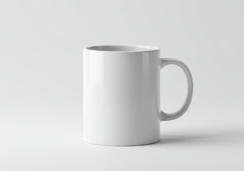 Fototapeta premium Plain white ceramic mug with handle on a white background for mockup purposes