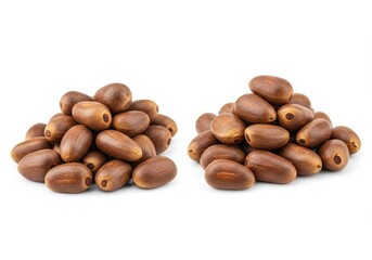Fototapeta premium Two small piles of brown jackfruit seeds are isolated against a white background in a studio shot