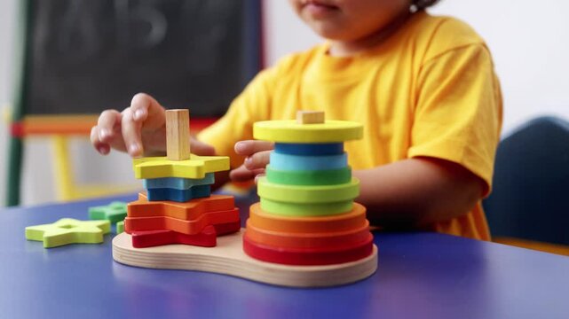 Child hands playing with didactic toys at preschool or daycare room. Education culture concept