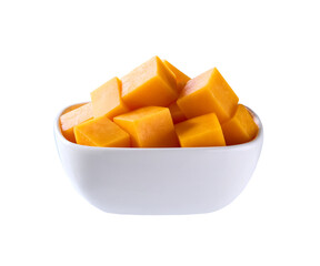 cheddar cheese cut into cubes in white plate isolated on white background .
