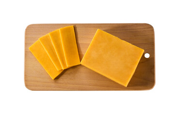 pieces of cheddar cheese on a cutting board isolated on a white background, top view.