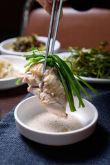 Boiled chicken pieces dipped in salt and served with vegetables