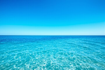 Fototapeta premium Stunning view of a crystal-clear turquoise ocean under a bright blue sky.