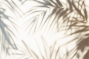 Abstract blurred palm leaf shadows on a light beige background.