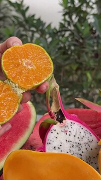 cut delicious tropical fruits healthy food mango bananas passion fruit watermelon oranges and other juicy Asia palm leaves in the background