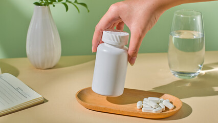 The sunlight gently shines through the desk. A hand lifts a medicine bottle from a plate, preparing...