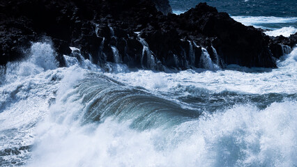 Rocky coast of the Atlantic ocean with waves.