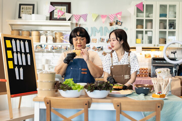 Small business owners are selling .Asian bakery  cake shop owner enjoy posting picture and review her cake on social media or online marketing streaming publish for advertising small business making m