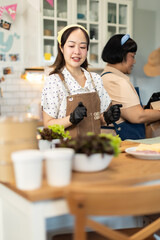 Small business owners are selling .Asian bakery  cake shop owner enjoy posting picture and review her cake on social media or online marketing streaming publish for advertising small business making m