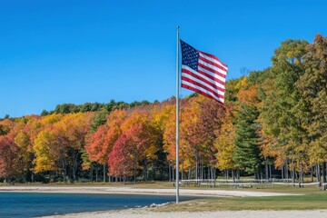 waving American flag with colorful fall trees in background, Grand Haven clear sky
