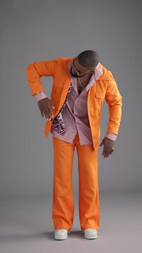 Robot, dancing and black man with fashion, retro clothes and colorful on gray background. African person, model and vintage outfit with movement, stylish wardrobe or smile with pride, funny or dancer