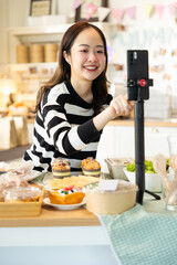 Small business owners are selling .Asian bakery  cake shop owner enjoy posting picture and review her cake on social media or online marketing streaming publish for advertising small business making m