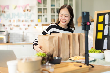 Small business owners are selling .Asian bakery  cake shop owner enjoy posting picture and review her cake on social media or online marketing streaming publish for advertising small business making m