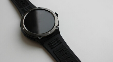 Smooth shadow border on the switched off screen of an electronic smart watch. Recharging of smart gadgets illustrative stock photo 