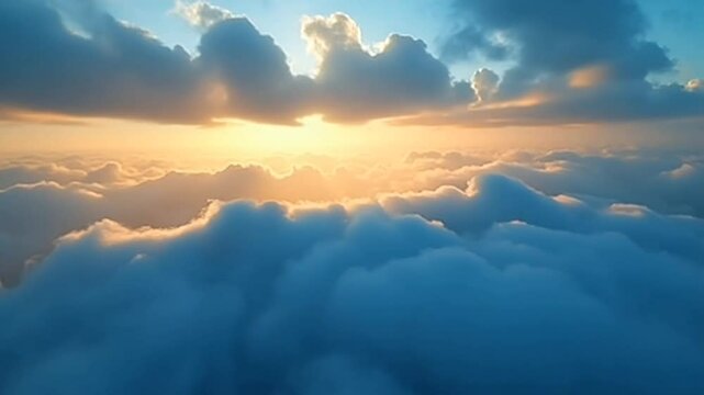 Soft golden sunlight breaks through a thick layer of fluffy clouds in the peaceful early morning sky
