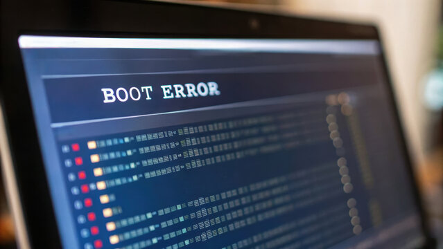 Computer boot error on screen with engineering code and technical details in blurred background