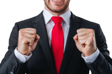 A man in a suit and red tie clenches his fists in excitement or triumph, with a big smile, against a black background.