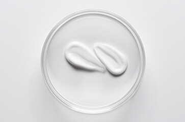 A sample of cosmetic moisturizing or anti-aging cream in a petri dish.