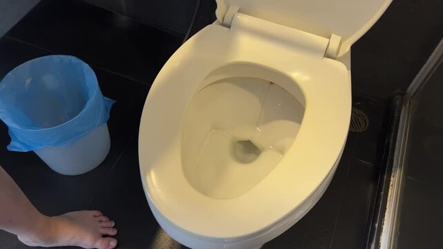 Half flush with half flow in a dual-flush toilet for economical consumption of fresh water. Eco-friendly use of plumbing, plumbing and sewerage in the bathroom. High quality 4k footage