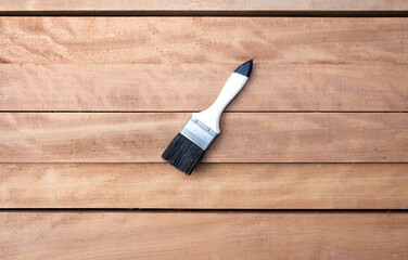 Wood product and paint brush in top view and horizontal composition. Construction tool and material...