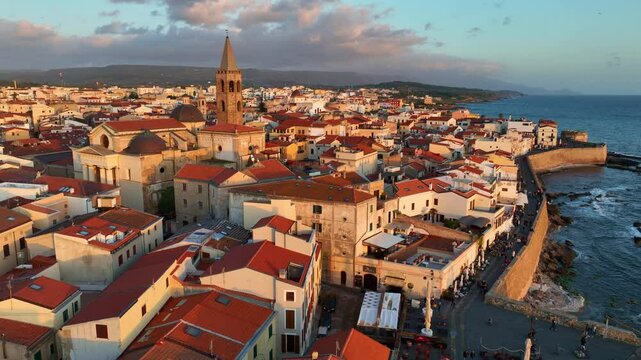 establishing drone shot of Alghero port and old town in Sardinia, vacations in Sardinia, Italy, aerial view of coastal ancient town in Sardegna, sunset in Alghero