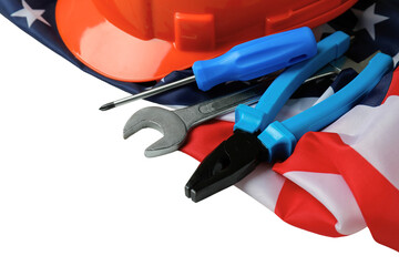 Labor Day features tools and a hard hat on an American flag, isolated on white, PNG