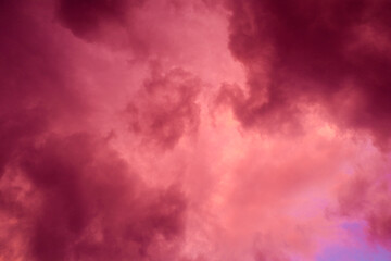 Obraz premium Fiery red storm clouds with dramatic lighting. Red storm clouds background. Dramatic red sky.