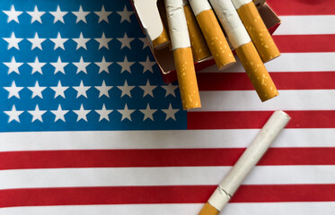  a cigarette on the background of the American flag. Concept of nicotine addiction problems in the US.