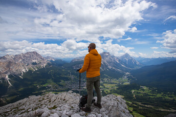 Fototapeta premium Hiker enjoys the view from Tofana di Mezzo, in the italian Dolomites.