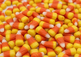 Pile of candy corn pieces with yellow orange and white color scheme