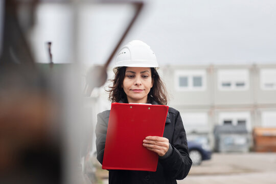 technician female working with helmet outside