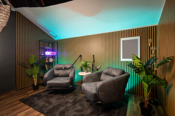 Professional podcast recording space with modern lighting and clean interior.