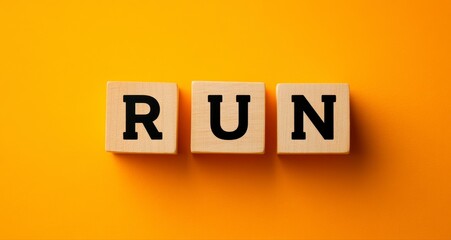 A wooden block with the word "run" written on it. The blocks are arranged in a way that creates a visually appealing and creative design. The orange background adds a warm