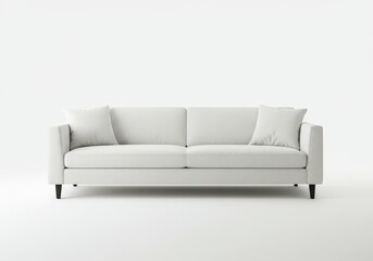 Obraz premium A minimalist white sofa with two pillows sits against a stark white background in a studio setting