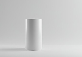 Minimalist composition of a white cylinder on a white surface with soft lighting and a neutral background