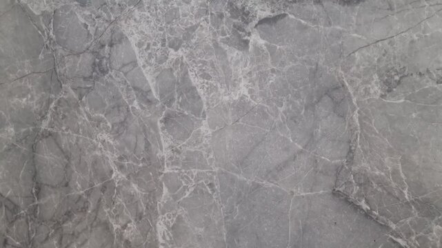 Natural gray marble surface with detailed veining. Real-time video texture background. Natural stone material concept