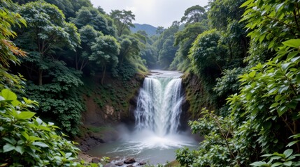 Serene Waterfall Surrounded by Lush Green Jungle and Rocky Terrain in Tranquil Nature Landscape