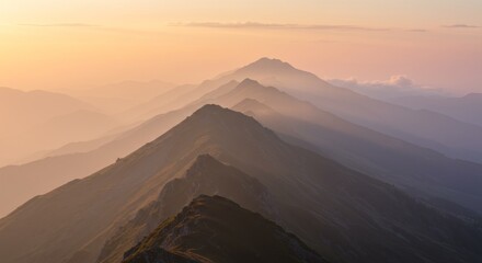 Fototapeta premium Layered Mountains at Sunset, Hazy Pink and Orange Hues