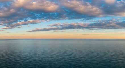 Fototapeta premium Tranquil Ocean Sunset with Pastel Clouds